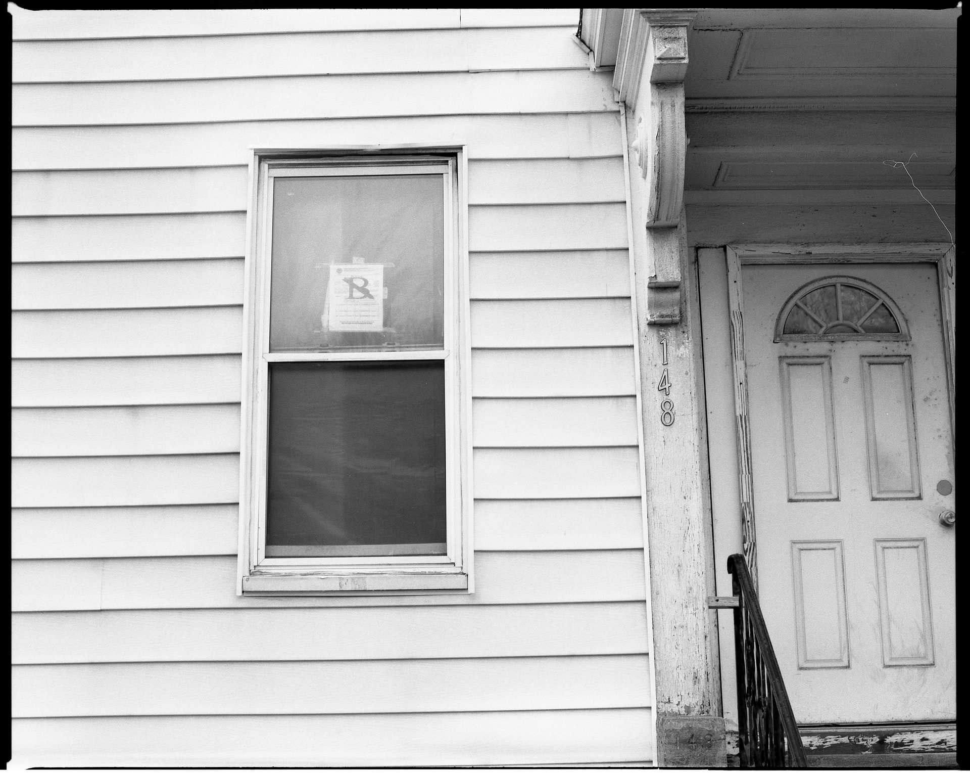 The front window of a house under eviction in Boston