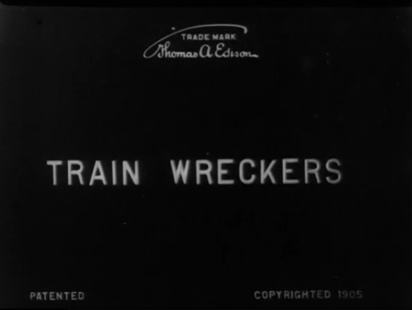 The opening title card of the 1905 film Train Wreckers. It only has the title of the film, the copyright year, and a "Trademark Thomas A Edison" ot the top, referring to the physical film reel itself.